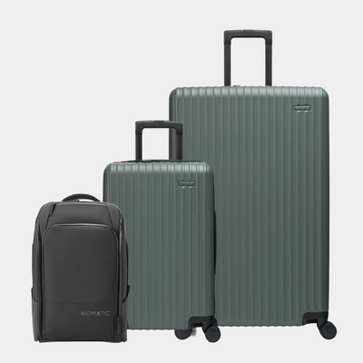 Set of three suitcases including a black backpack on a light gray background#color_moss