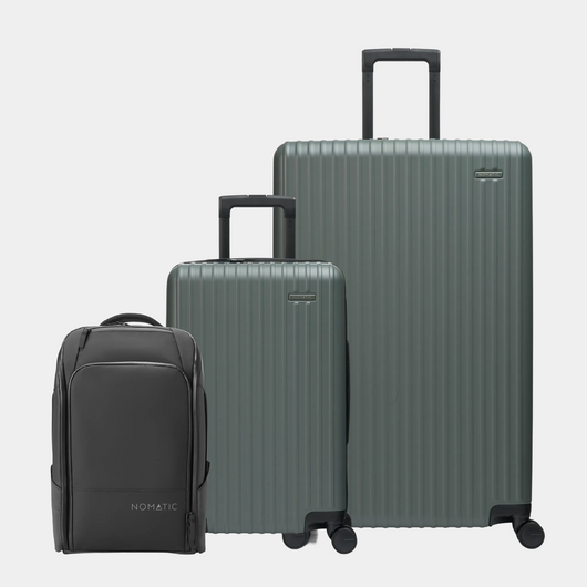 Set of three suitcases including a black backpack on a light gray background#color_moss